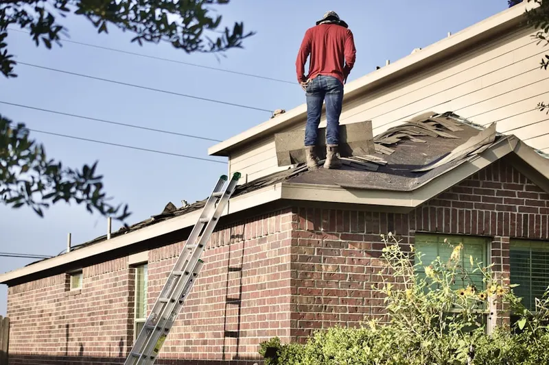 Professional roofer working on a residential roof in Saddleback Ridge